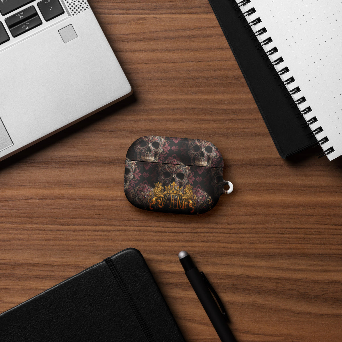 Velvet Ink Market Ornate Skull & Gold Crest AirPods Case, front view featuring ornate skulls and a gold VIM crest (additional photo 6).