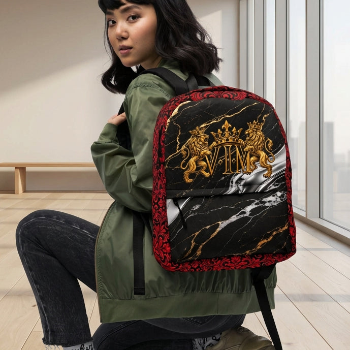 A model wearing an olive green jacket, black jeans, and beige sneakers is crouching while wearing a black backpack with a red floral border and a gold crest design on a marble pattern.