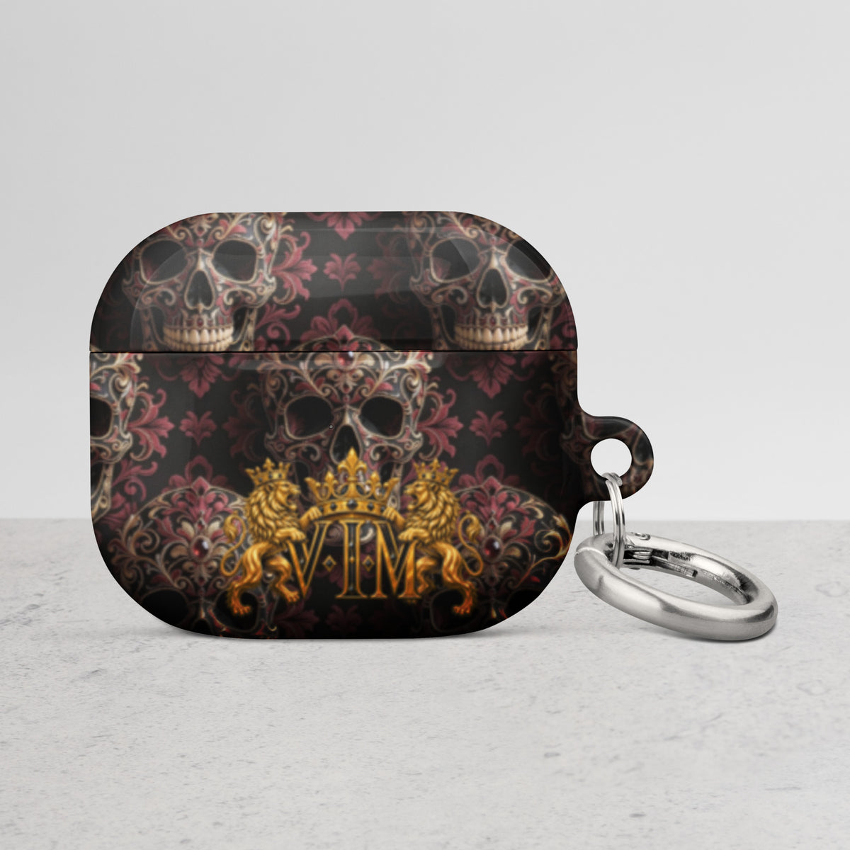 Velvet Ink Market Ornate Skull & Gold Crest AirPods Case, front view featuring ornate skulls and a gold VIM crest.