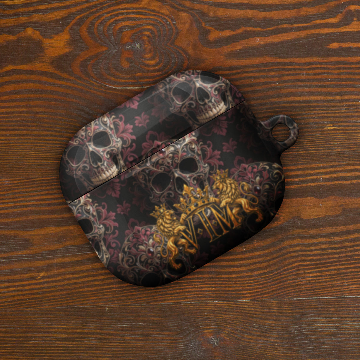 Velvet Ink Market Ornate Skull & Gold Crest AirPods Case, front view featuring ornate skulls and a gold VIM crest (additional photo 3).