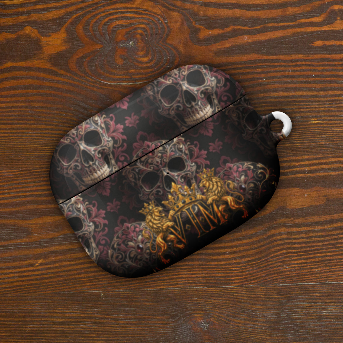 Velvet Ink Market Ornate Skull & Gold Crest AirPods Case, front view featuring ornate skulls and a gold VIM crest (additional photo 4).