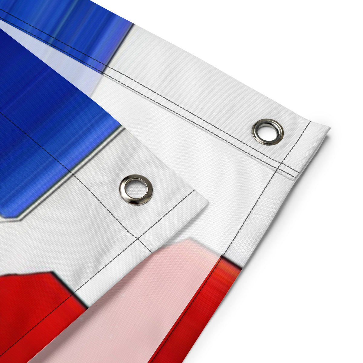 Close-up of the Union Jack flag fabric showing stitched hems and two metal hanging grommets.