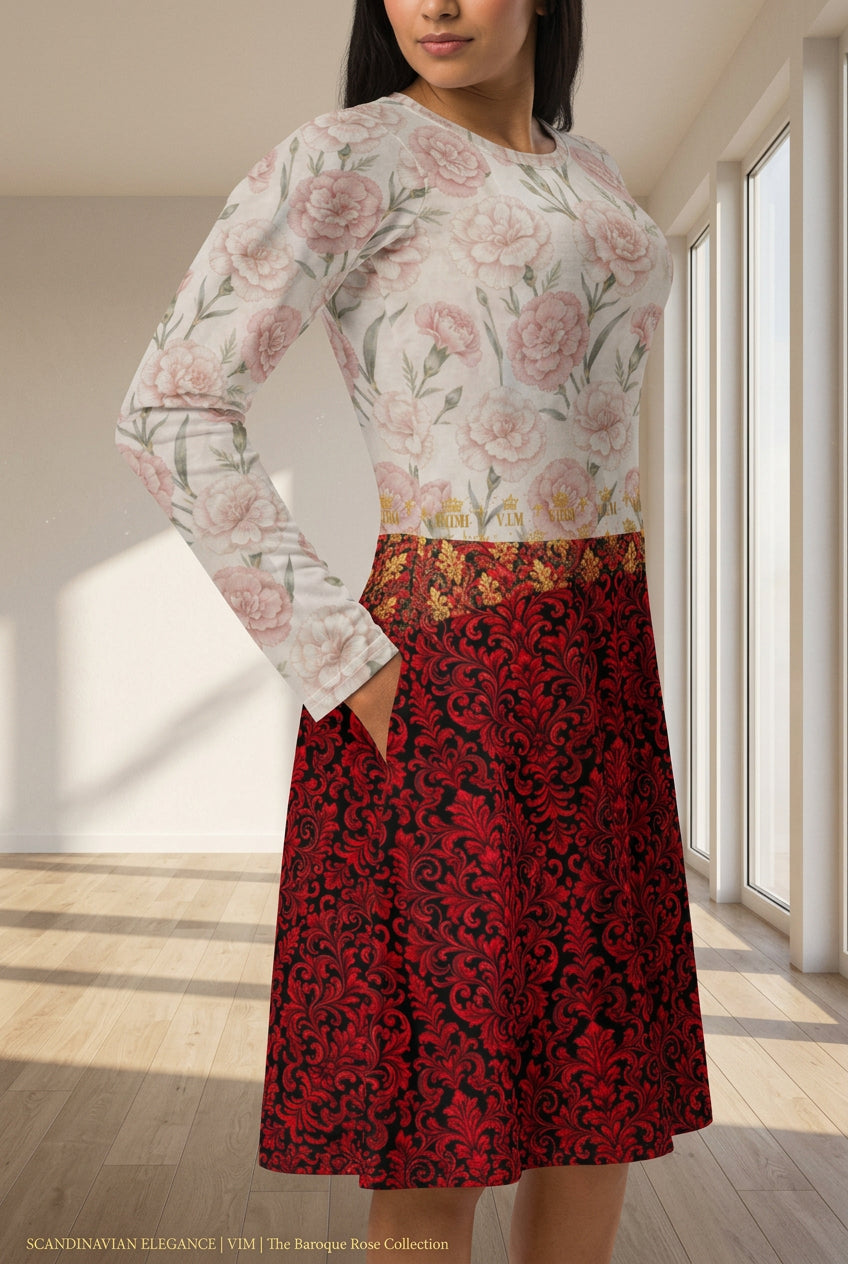 A woman wearing a long-sleeve dress with a cream floral bodice and a red and black ornate patterned skirt, shown against a plain white background.
