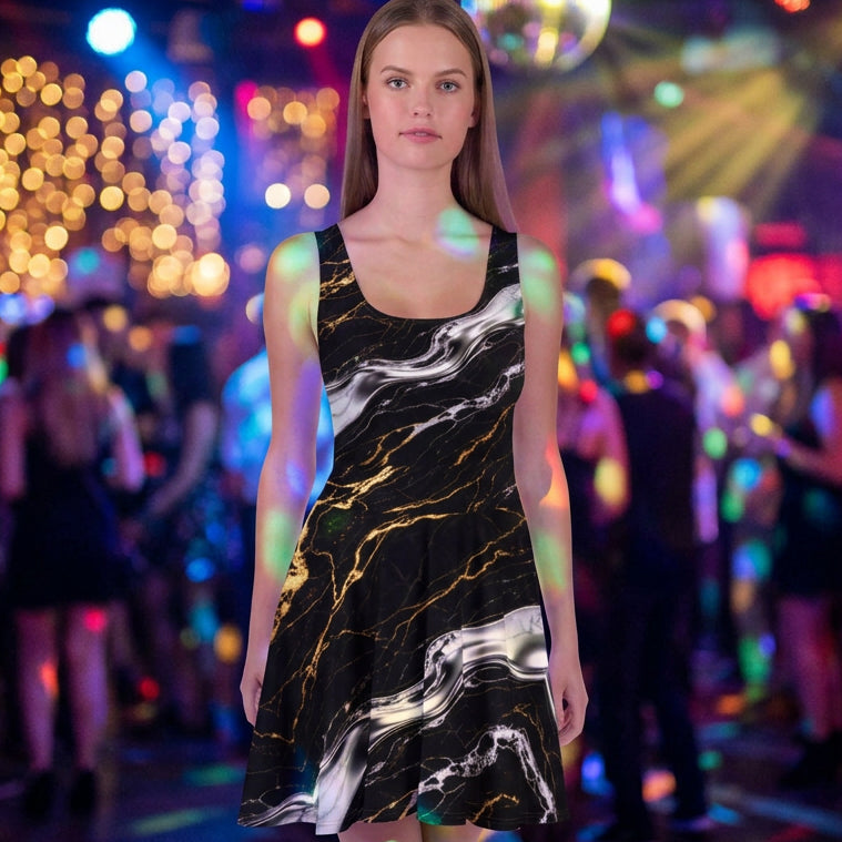 A woman modeling a sleeveless skater dress with a black marble pattern accented by white and gold veining, set against a plain white background.