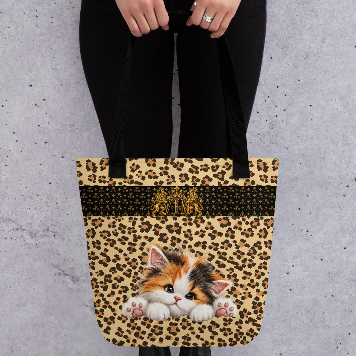 V.I.M kitten leopard-print tote bag with black handles, held by hand